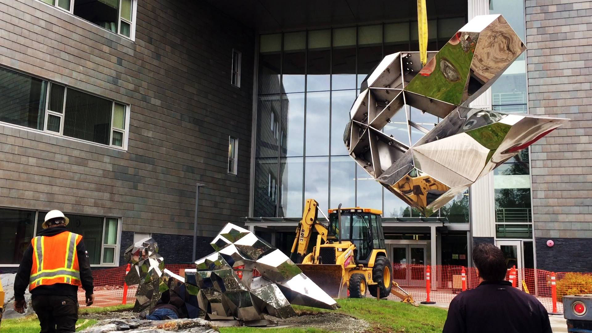 Heath Satow Sculpture - Installing Inflorescence, a polished stainless steel art sculpture by Heath Satow for UAA in Anchorage, AK