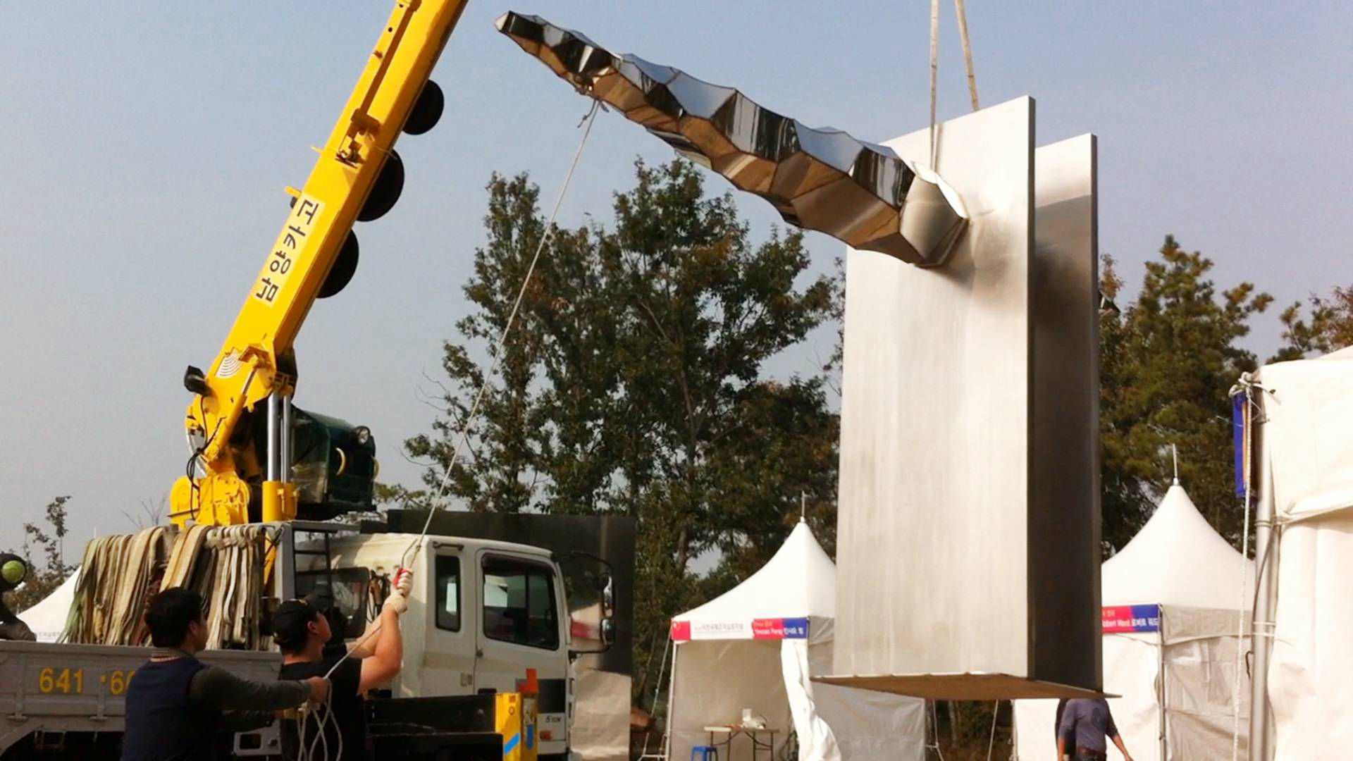 Heath Satow Sculpture - installing Transition, a stainless steel public art sculpture in Icheon, Korea