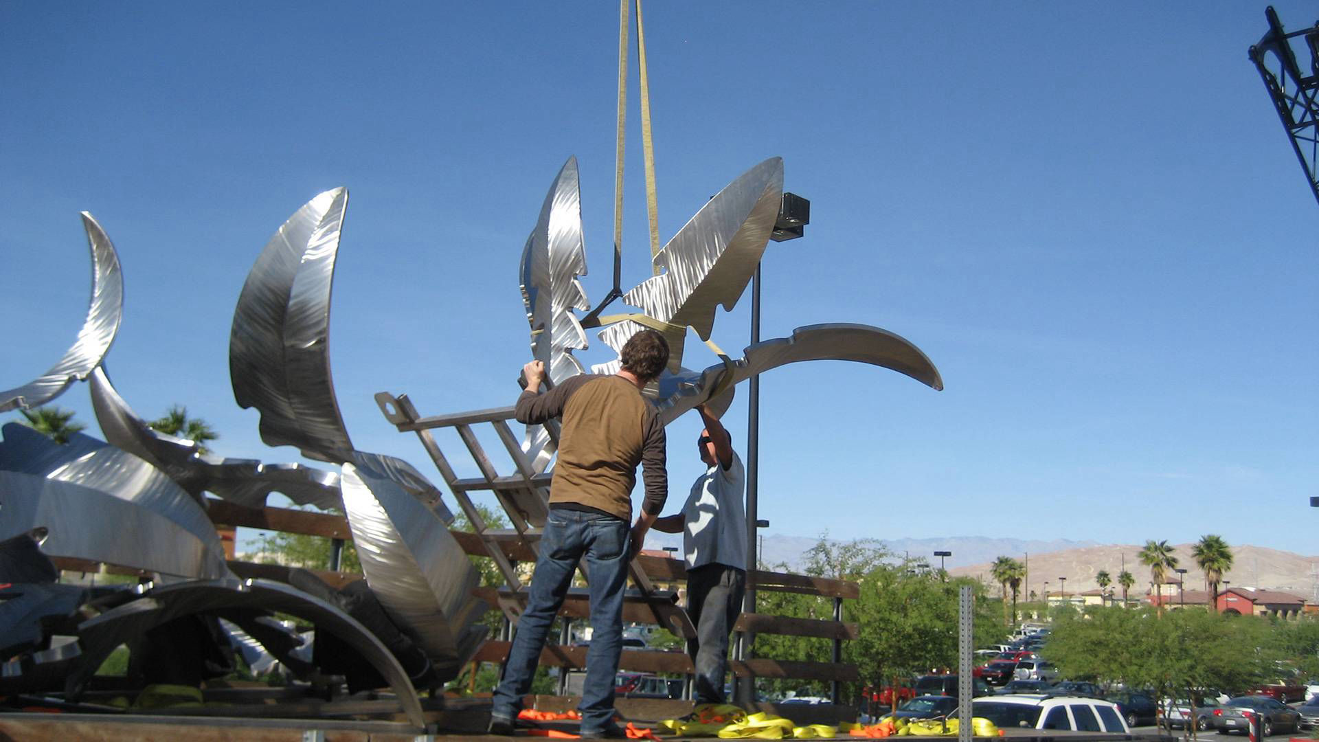 Heath Satow Sculpture - installing Tumbling Weed, a stainless steel public art sculpture in Palm Desert, CA