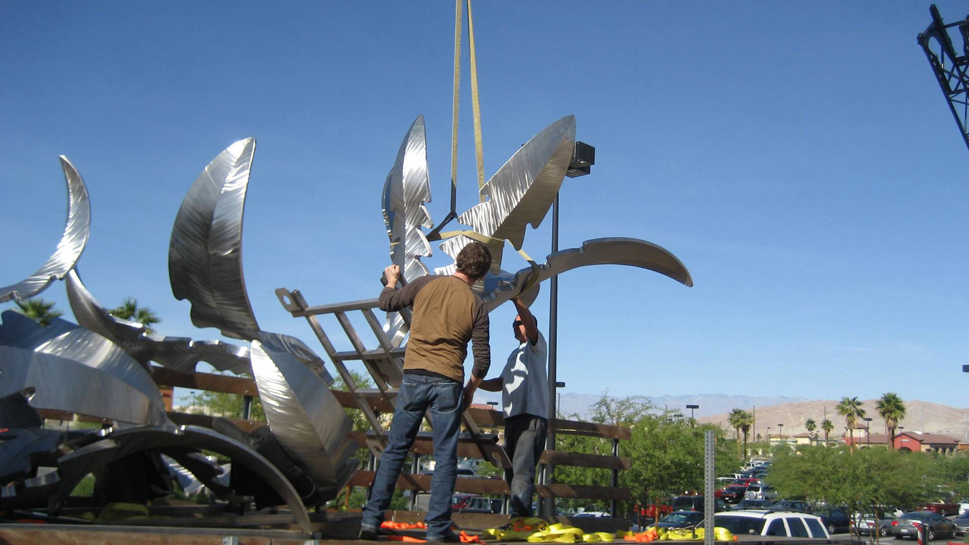 Heath Satow Sculpture - installing Tumbling Weed, a stainless steel public art sculpture in Palm Desert, CA