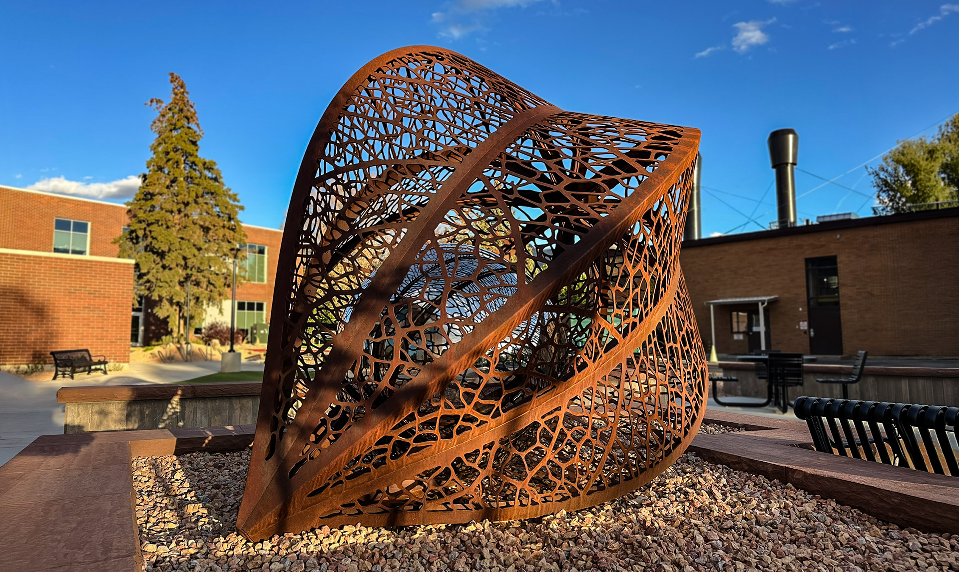 The Seed — corten and mirror-polished stainless steel public art sculpture by Heath Satow, Cedar City, UT